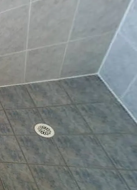 The same shower floor after new grout and sealing